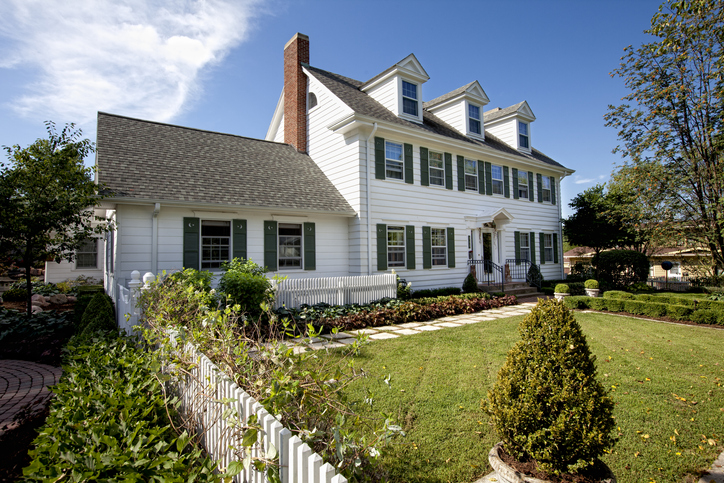 Traditional connecticut home with white siding, shutters, nice landscaping