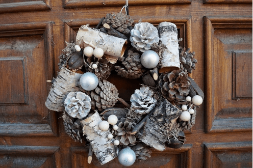 brown wreath on dark wood door