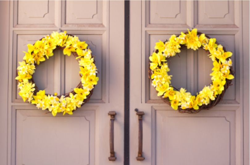 Yellow flower wreath on tan door