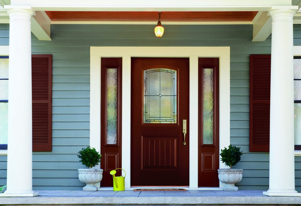 A red mahogany stained fiberglass door with privacy sidelights.
