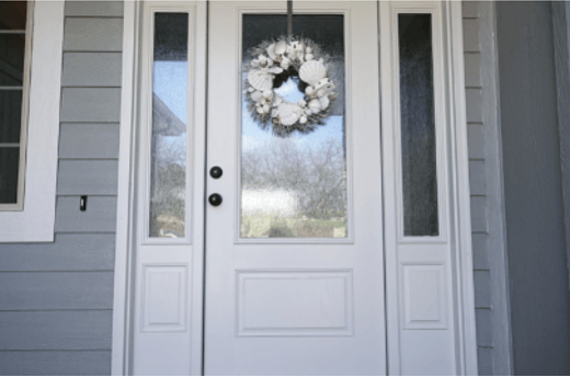 White wreath on white glass door