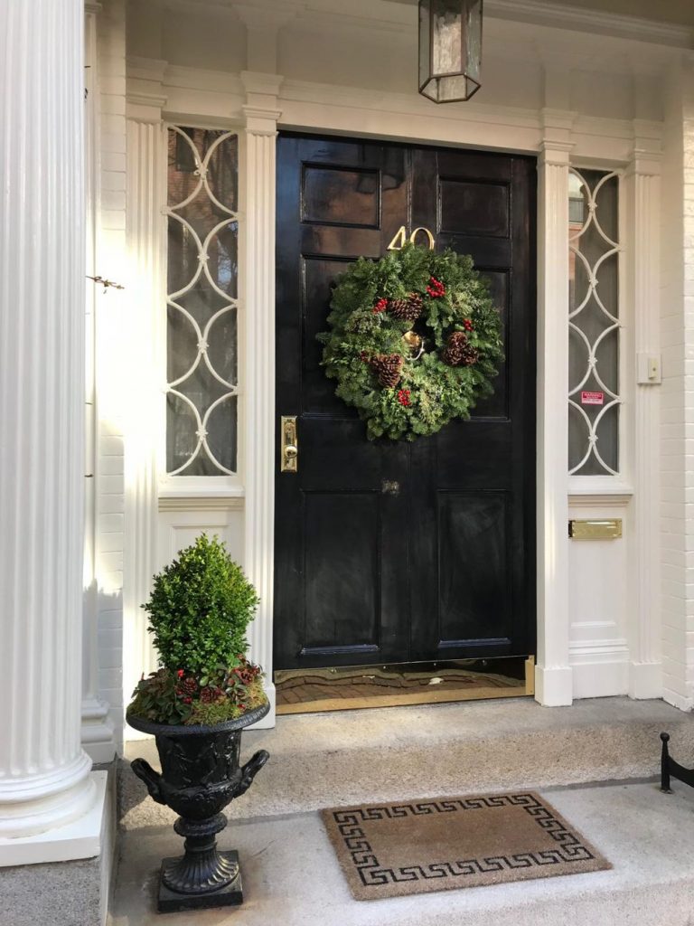Adding a welcome mat, a plant and a seasonal wreathe will increase your homes curb appeal