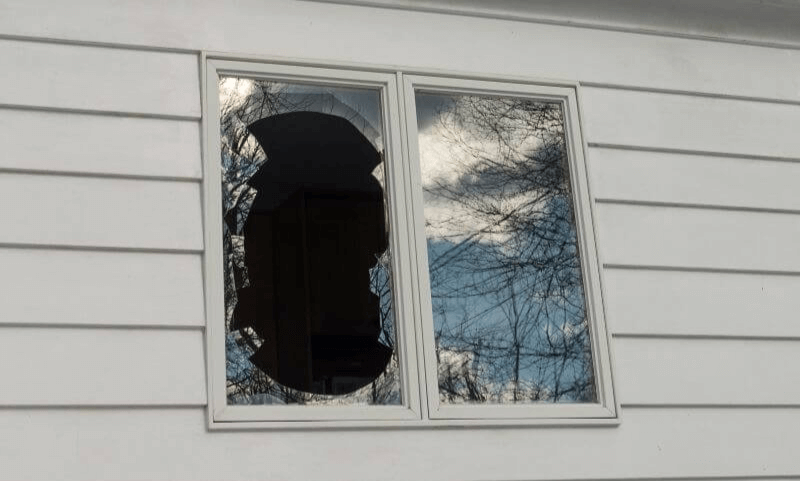 Broken window on white home